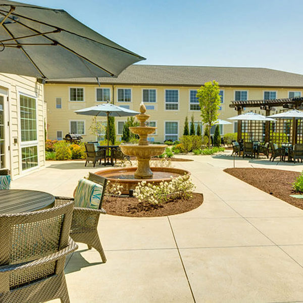 Photo of the outdoor patio with patio furniture and umbrellas at Traditions at Bridgepointe Gardens